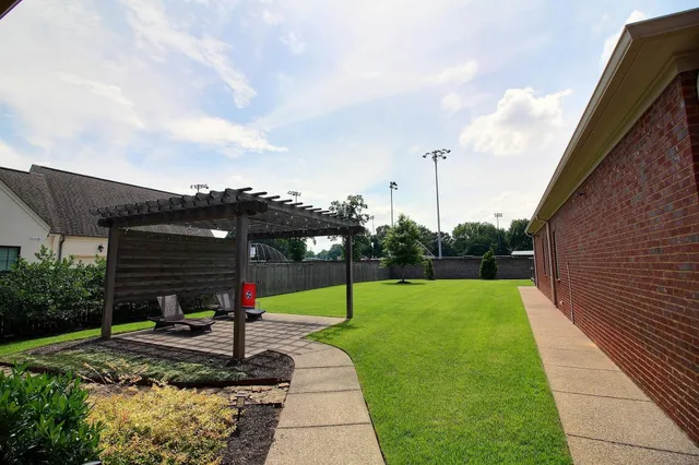 a backyard of a house with lots of green space and lake view