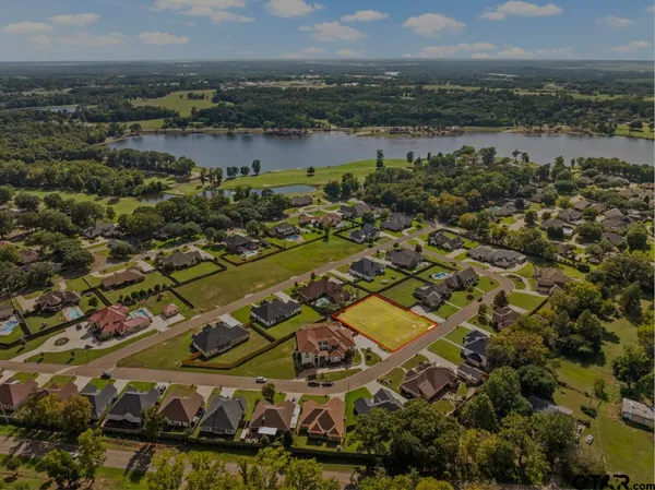 an aerial view of residential building with outdoor space and lake view