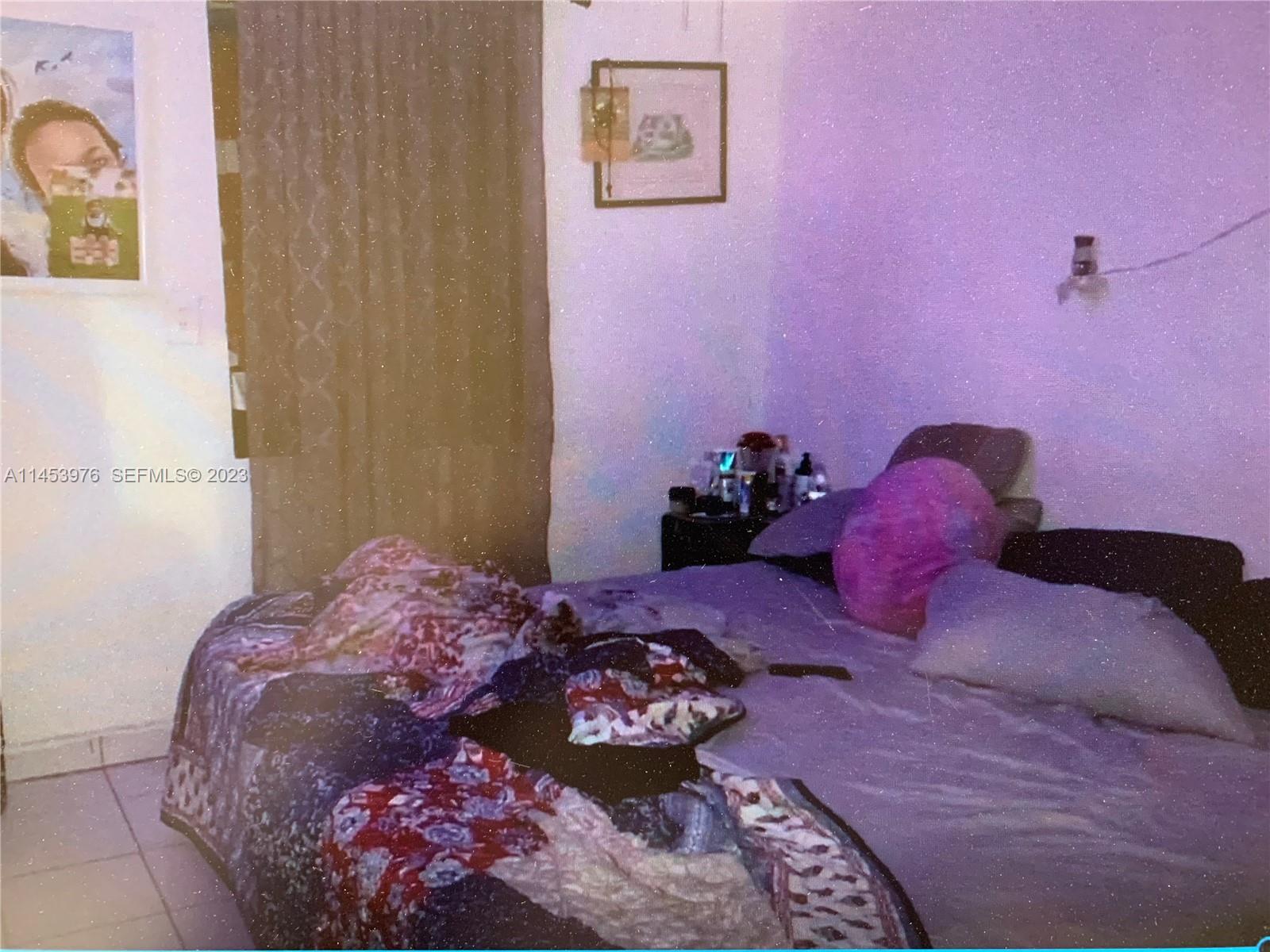 1104 Northwest 6 Street Miami, FL 33136 - Photo 11 of 16 a bed room with a bed and a couch