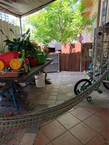 a view of a backyard with sitting area and furniture