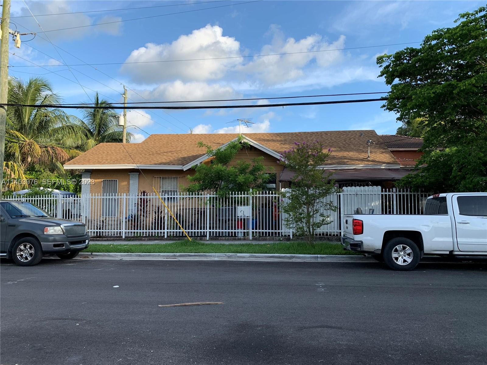 1104 Northwest 6 Street Miami, FL 33136 - Photo 2 of 16 a car parked in front of a house