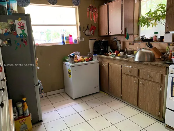 a kitchen with a sink cabinets and utility room