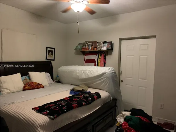 a bedroom with bed and a chandelier