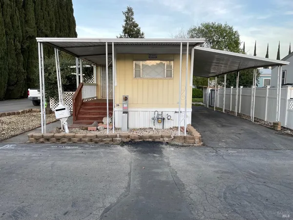 a view of a house with wooden floor and wooden fence