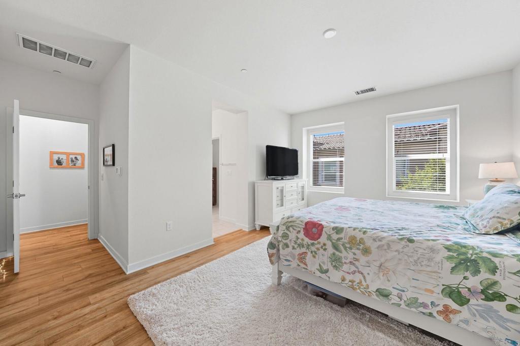 122 Diamante Road San Marcos, CA 92078 - Photo 13 of 36 a bedroom with a bed and a flat screen tv