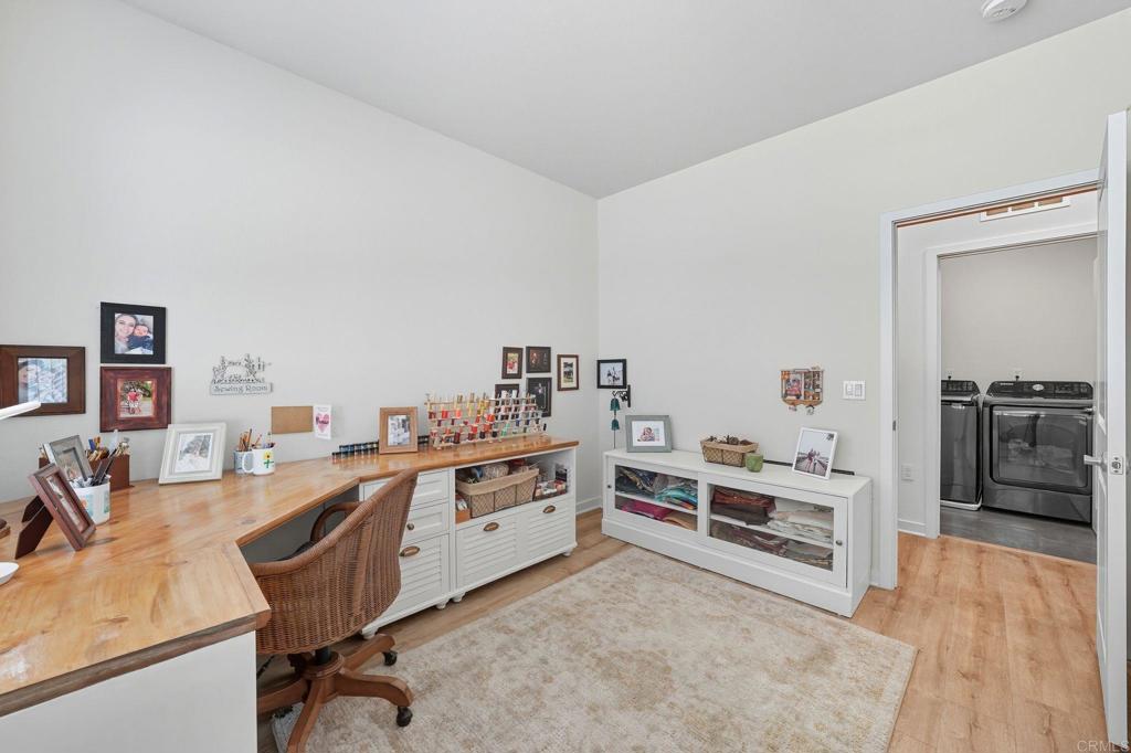 122 Diamante Road San Marcos, CA 92078 - Photo 16 of 36 a room with furniture a stove and a wooden floor