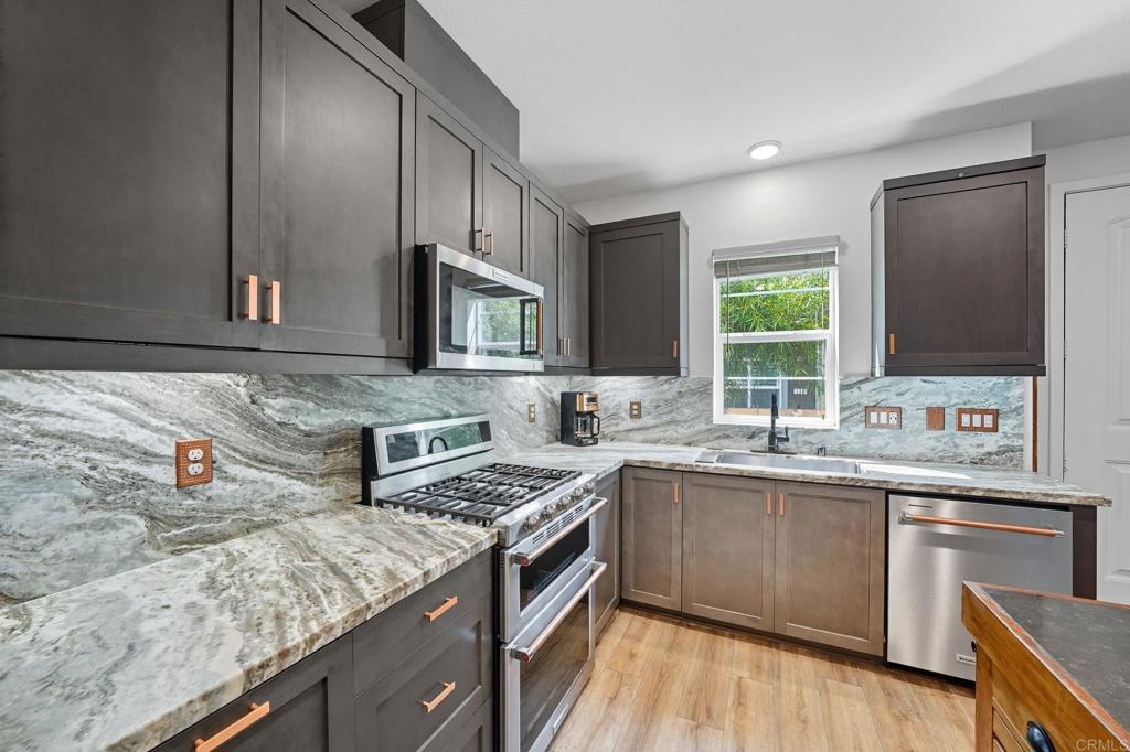 122 Diamante Road San Marcos, CA 92078 - Photo 4 of 36 a kitchen with stainless steel appliances granite countertop a sink stove and cabinets