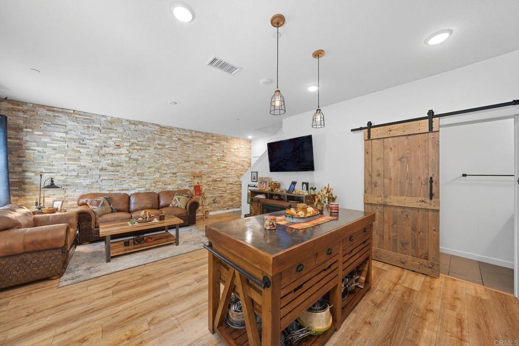 122 Diamante Road San Marcos, CA 92078 - Photo 8 of 36 a kitchen that has a kitchen island wooden floor and a window