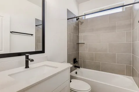 a bathroom with a sink a toilet and a bathtub