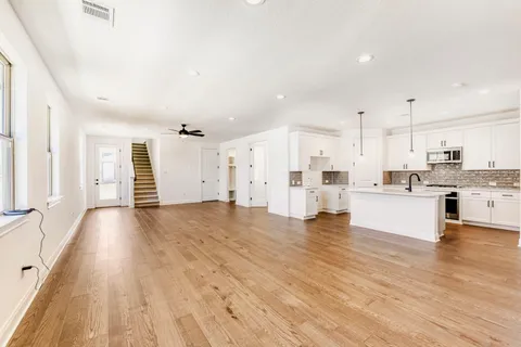 a view of kitchen with wooden floor and windows