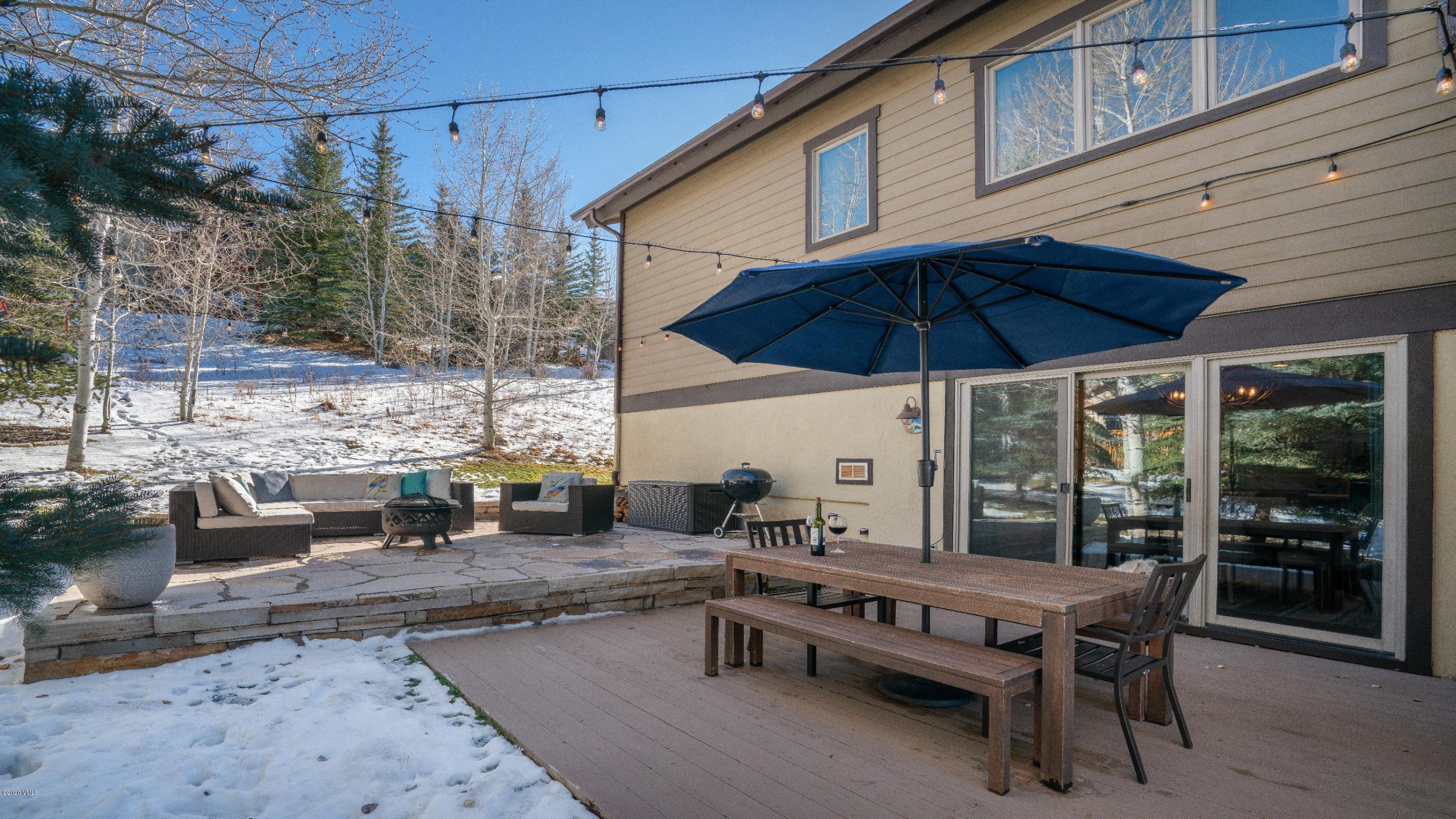52 Andover Trail Edwards, CO 81632 - Photo 16 of 33 a view of a roof deck with table and chairs under an umbrella