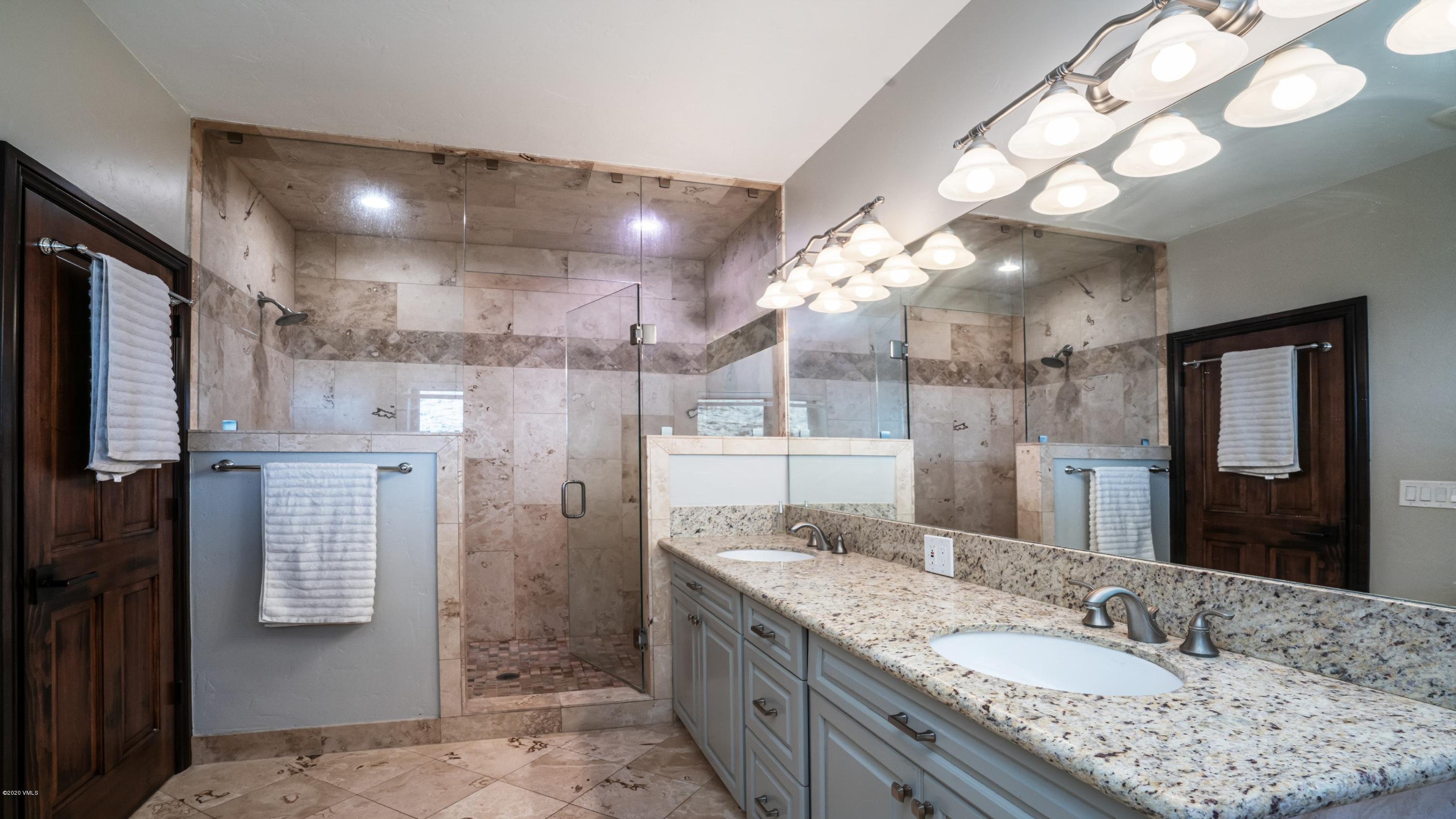 52 Andover Trail Edwards, CO 81632 - Photo 25 of 33 a bathroom with a granite countertop sink mirror and shower