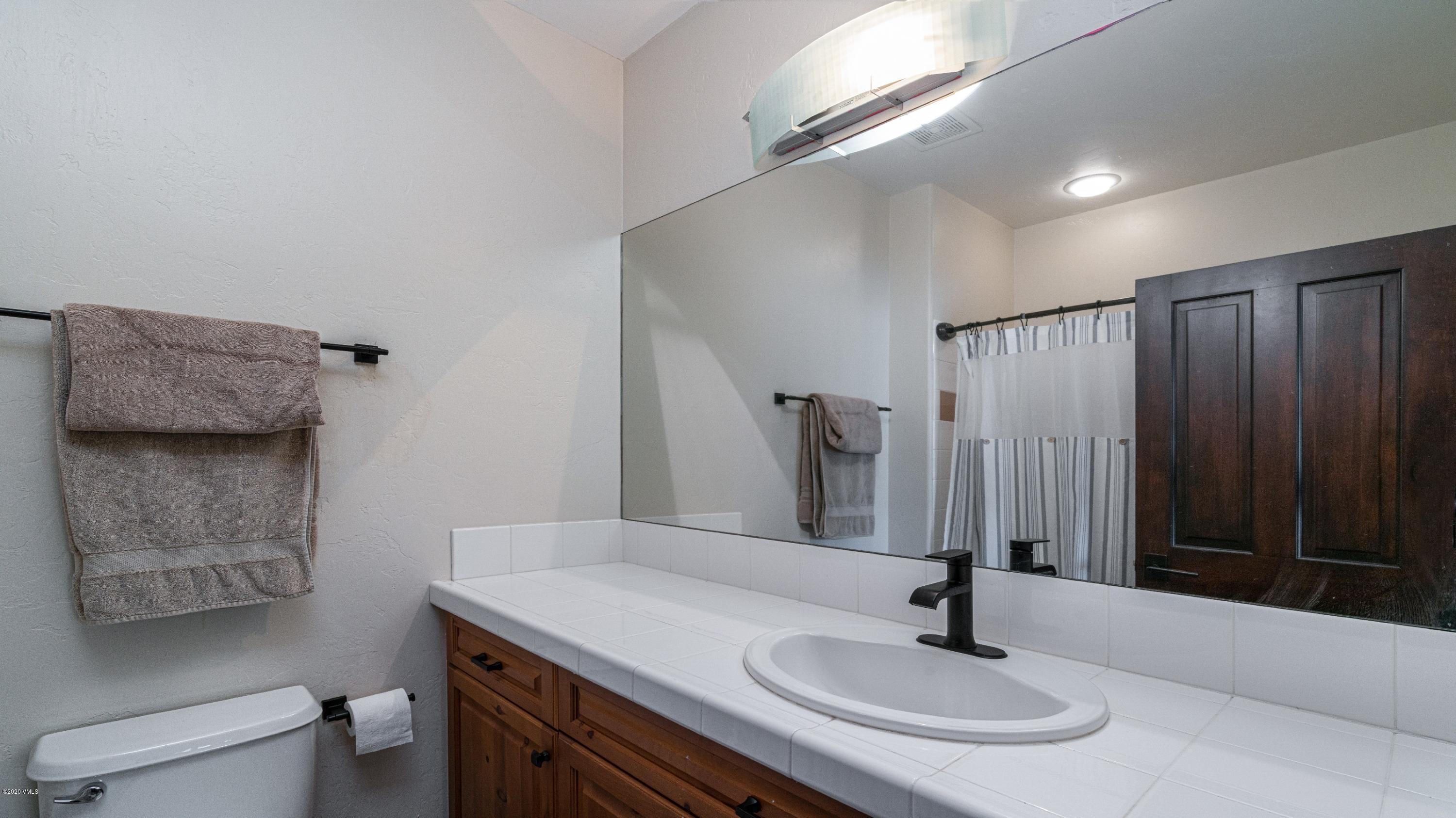 52 Andover Trail Edwards, CO 81632 - Photo 28 of 33 a bathroom with a sink and a mirror