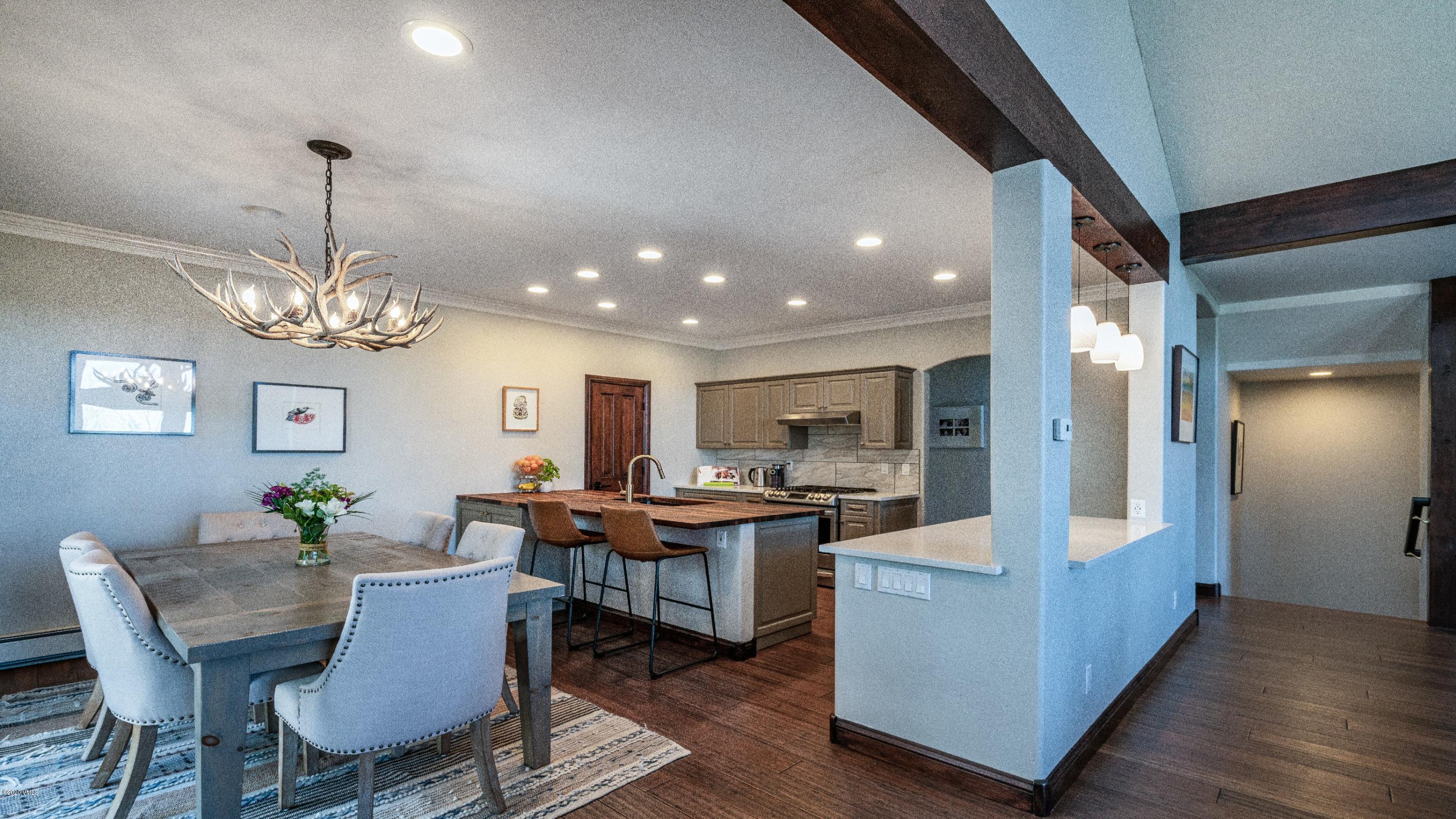 52 Andover Trail Edwards, CO 81632 - Photo 8 of 33 a view of a dining room with furniture a chandelier and wooden floor