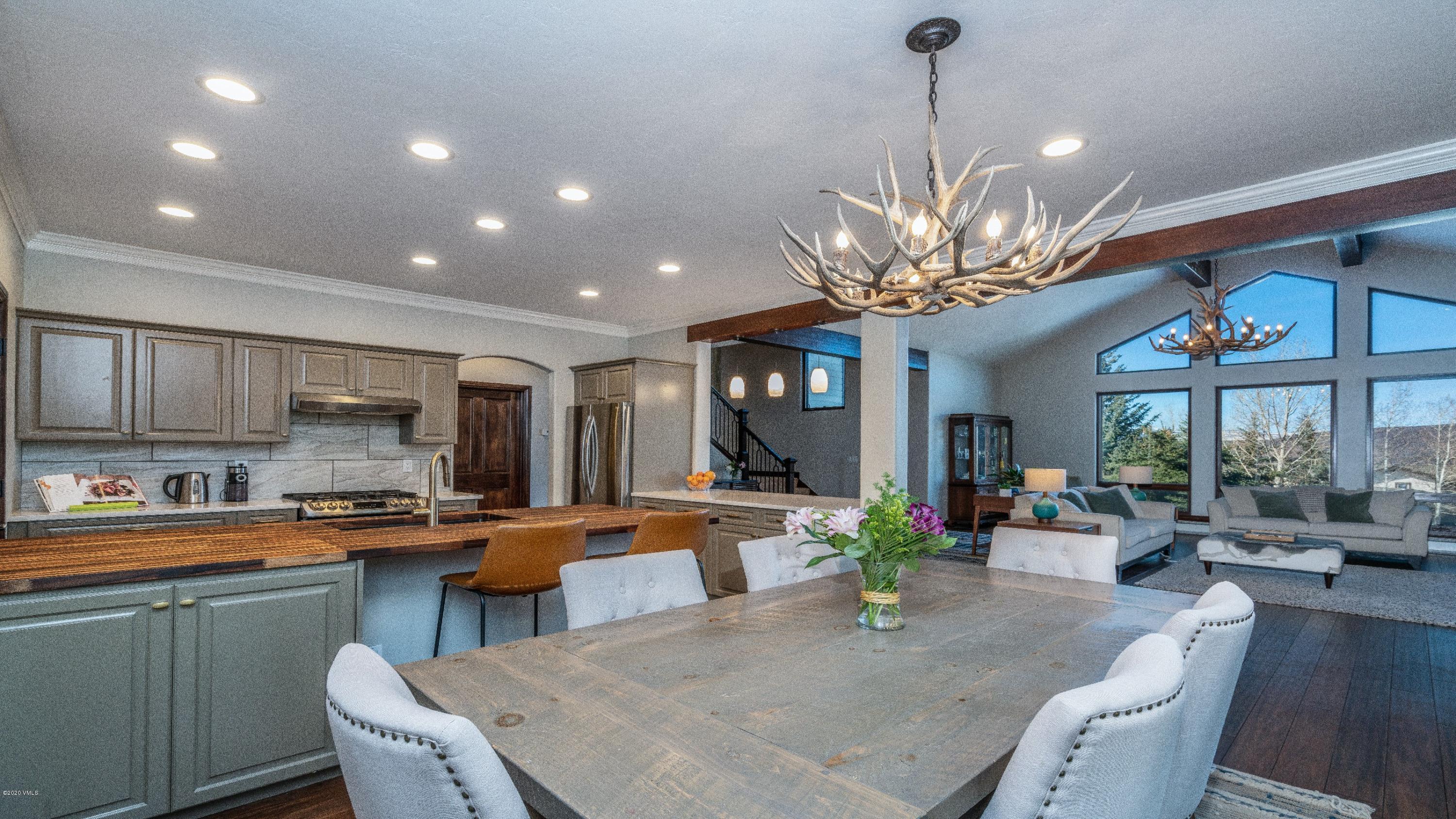 52 Andover Trail Edwards, CO 81632 - Photo 9 of 33 a view of a dining room and livingroom with furniture wooden floor a chandelier