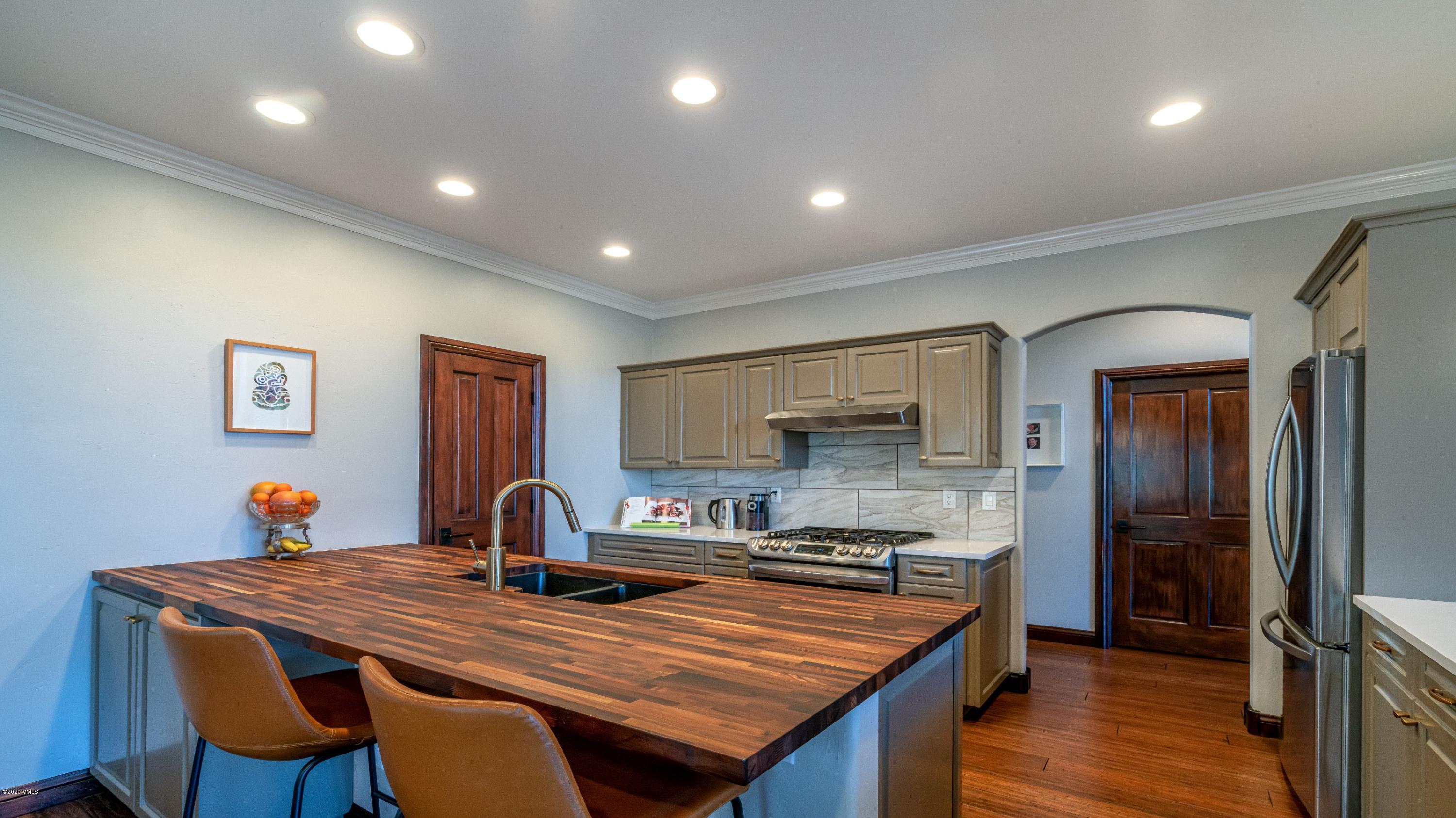 52 Andover Trail Edwards, CO 81632 - Photo 10 of 33 a dining hall with stainless steel appliances granite countertop a sink a stove a refrigerator with a dining table and chairs