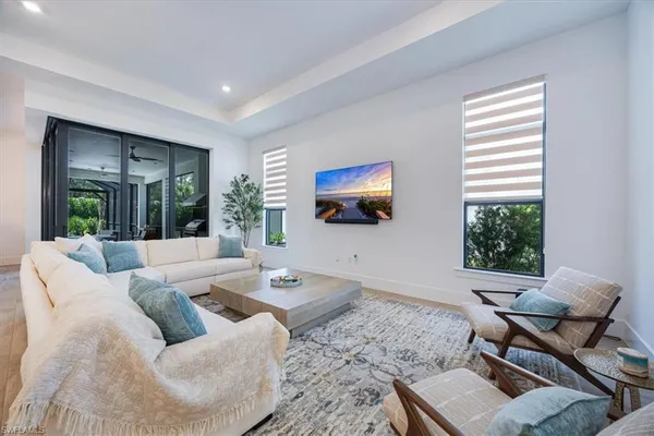 a living room with furniture tv and a window
