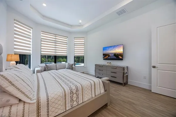 a bedroom with a bed and a flat screen tv