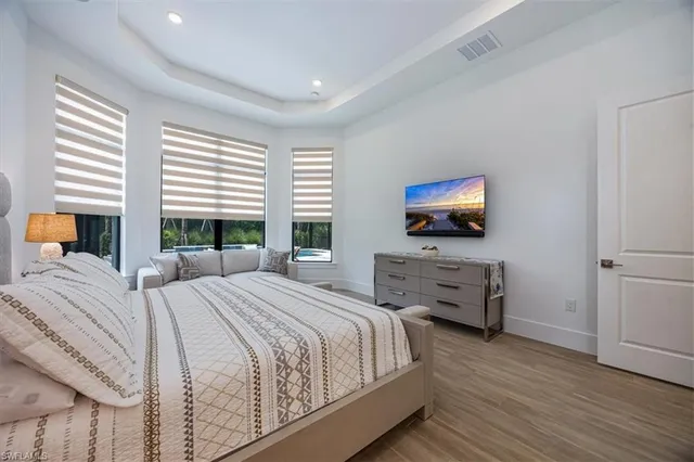 a bedroom with a bed and a flat screen tv