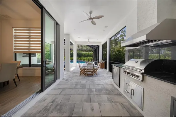 a view of a living room and kitchen outdoor space