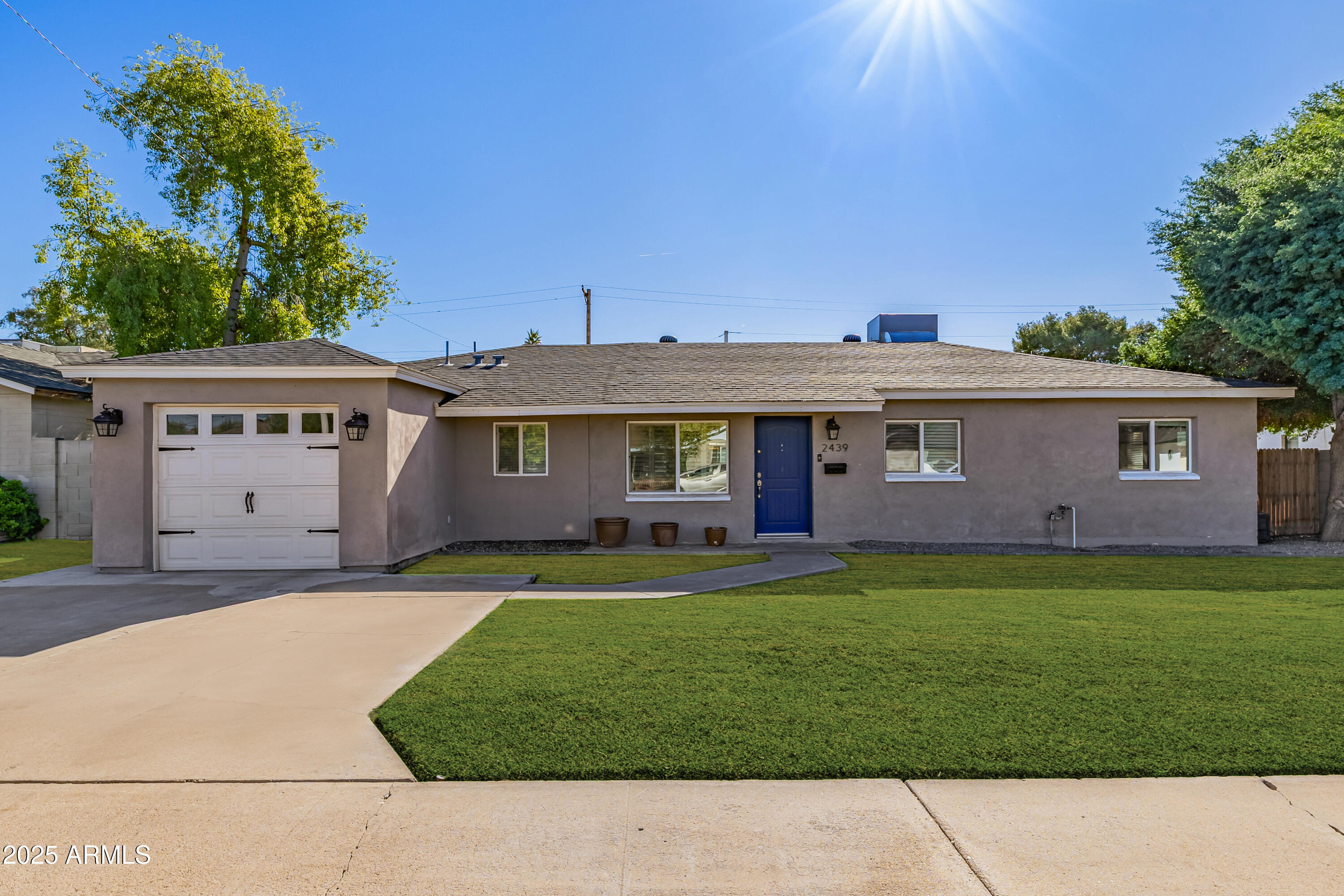 2439 East Minnezona Avenue Phoenix, AZ 85016 - Photo 1 of 25 a front view of a house with a garden