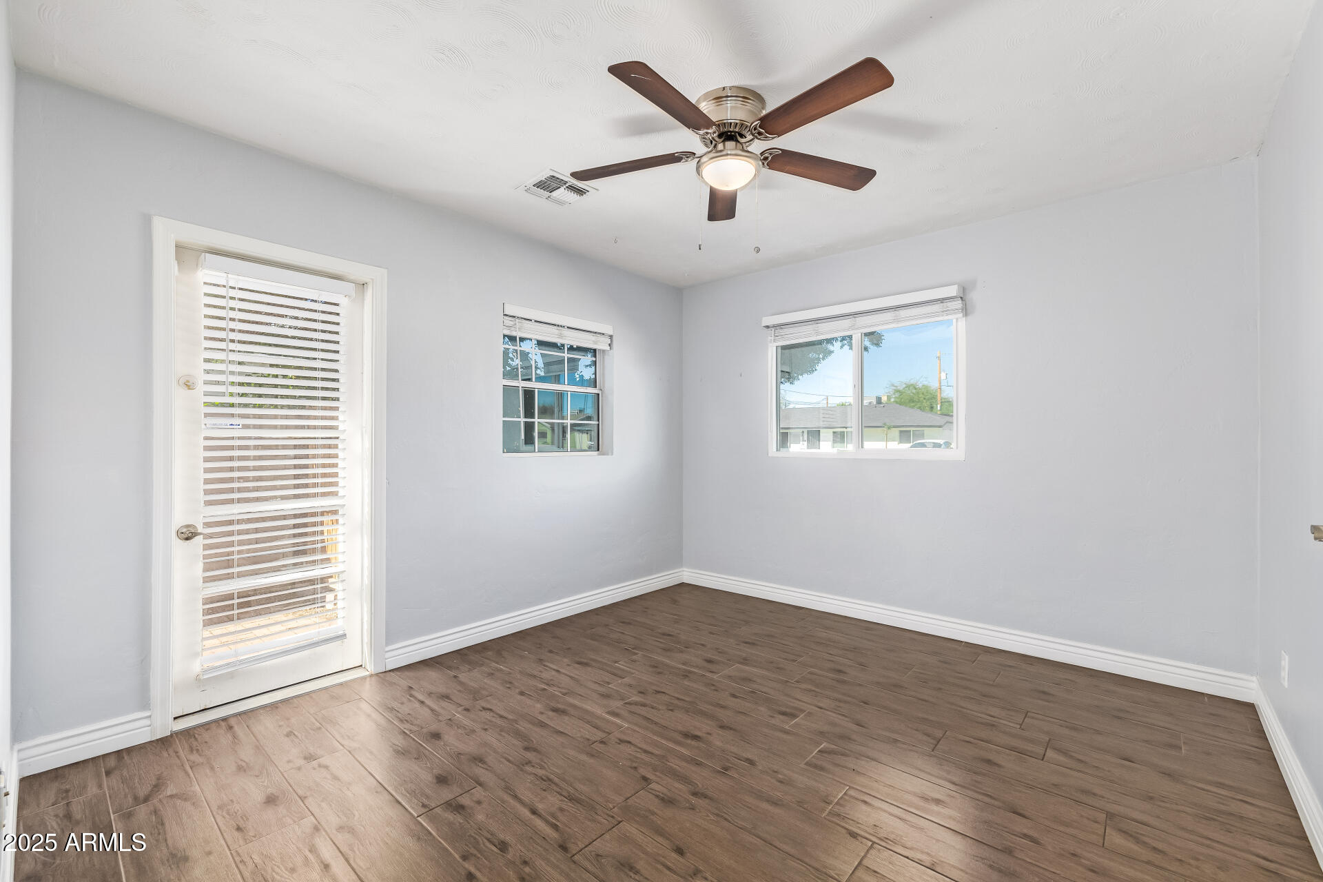 2439 East Minnezona Avenue Phoenix, AZ 85016 - Photo 16 of 25 a view of a big room with wooden floor and windows