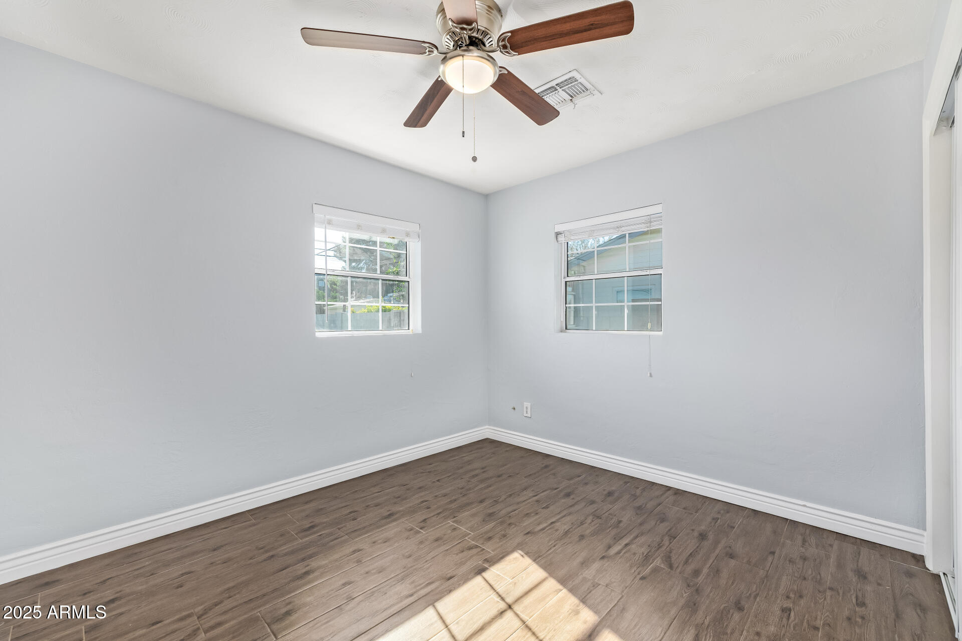 2439 East Minnezona Avenue Phoenix, AZ 85016 - Photo 18 of 25 wooden floor in an empty room with a window