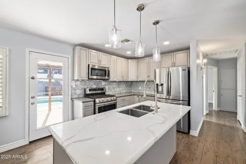 a kitchen that has a lot of cabinets and refrigerator