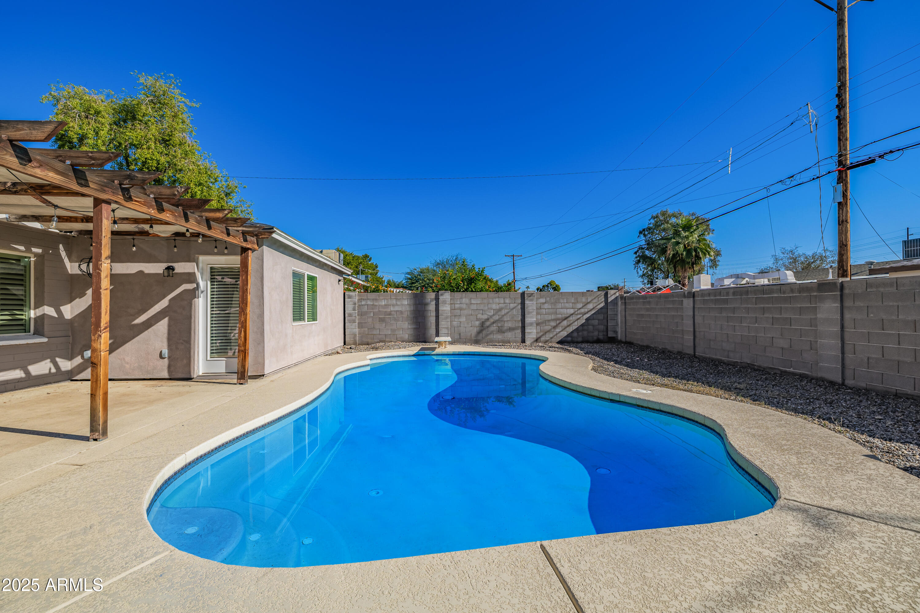 2439 East Minnezona Avenue Phoenix, AZ 85016 - Photo 23 of 25 a view of a swimming pool with a lounge chairs