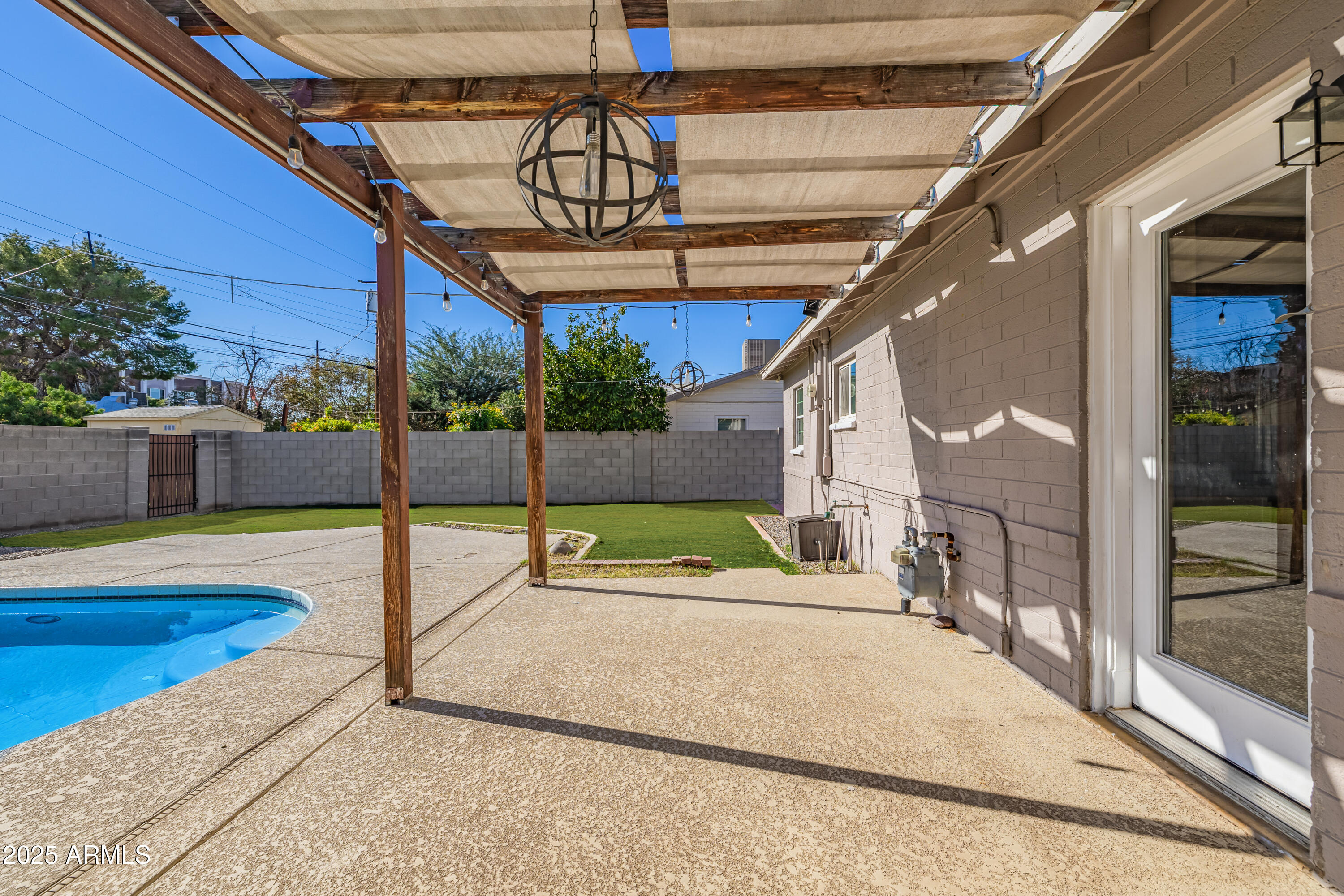 2439 East Minnezona Avenue Phoenix, AZ 85016 - Photo 24 of 25 a swimming pool with potted plants and palm trees