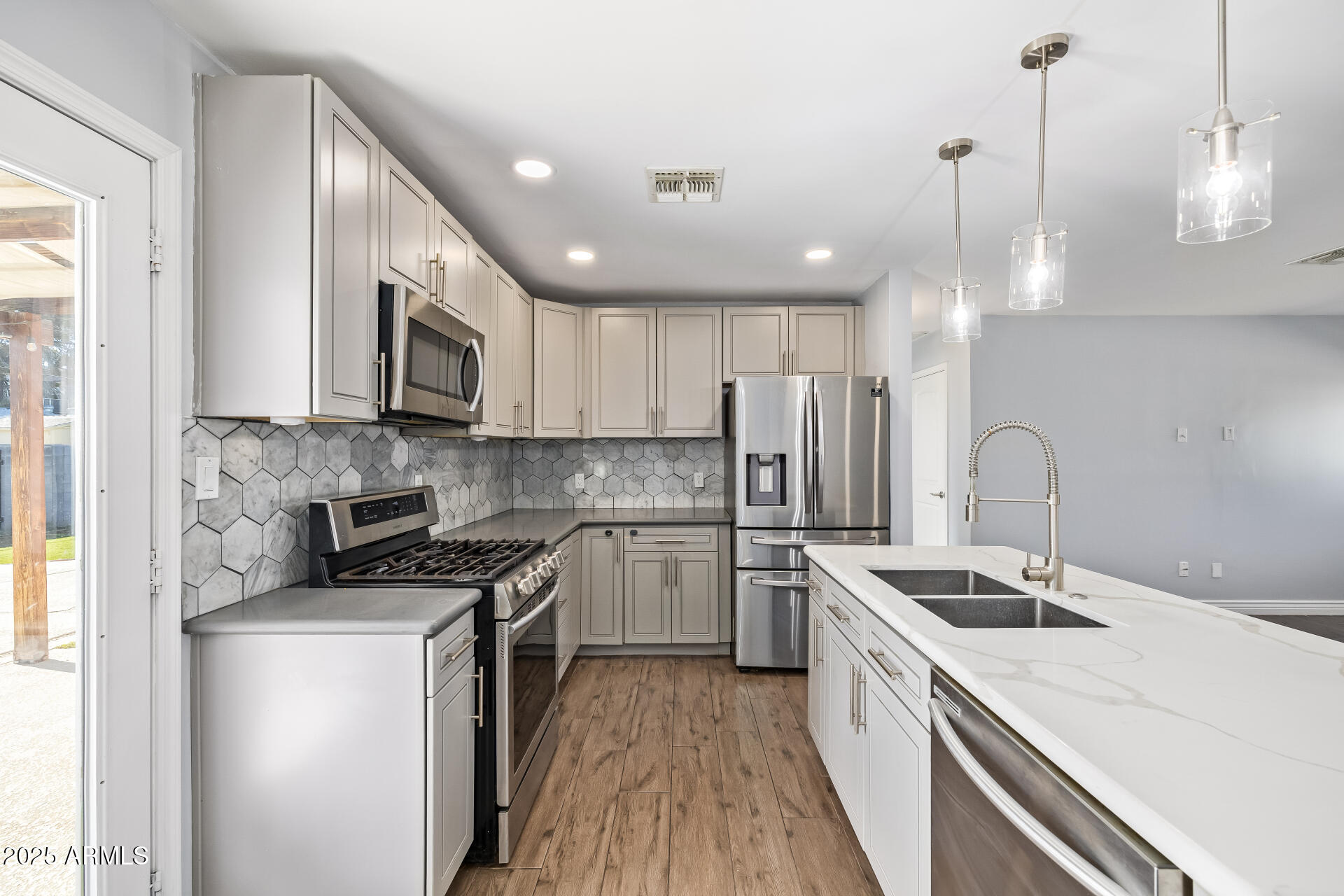 2439 East Minnezona Avenue Phoenix, AZ 85016 - Photo 3 of 25 a kitchen with a sink a counter space stainless steel appliances and cabinets