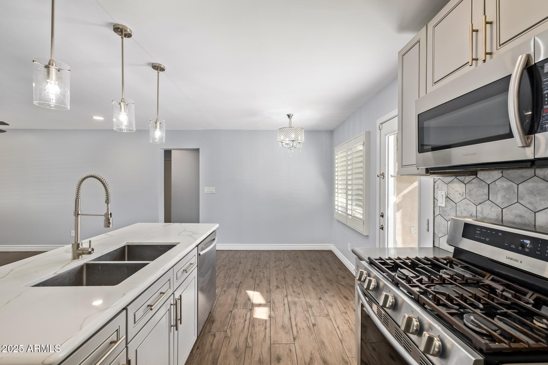 2439 East Minnezona Avenue Phoenix, AZ 85016 - Photo 4 of 25 a kitchen with stainless steel appliances a stove a sink and a microwave
