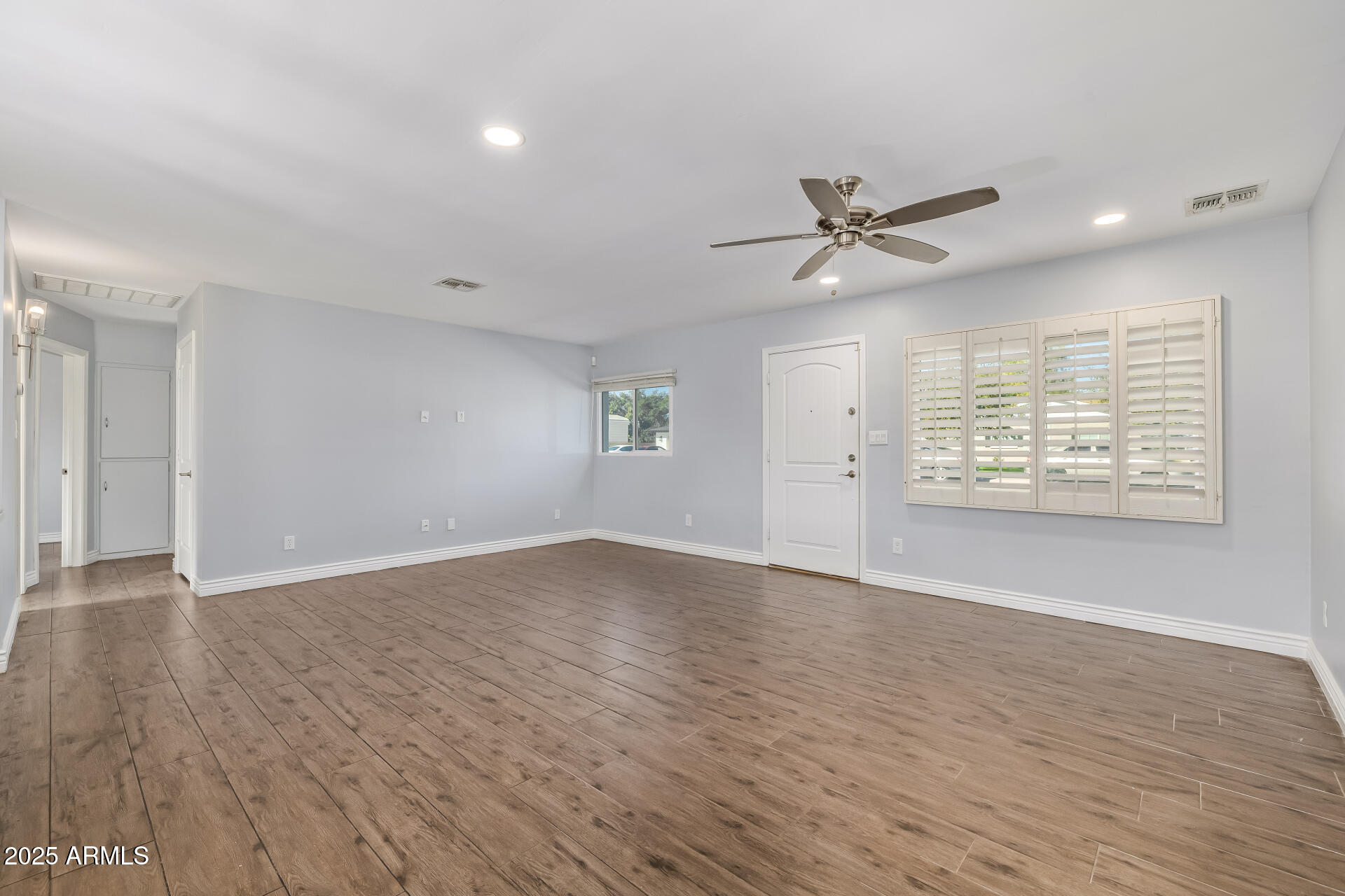 2439 East Minnezona Avenue Phoenix, AZ 85016 - Photo 8 of 25 wooden floor in an empty room with a window