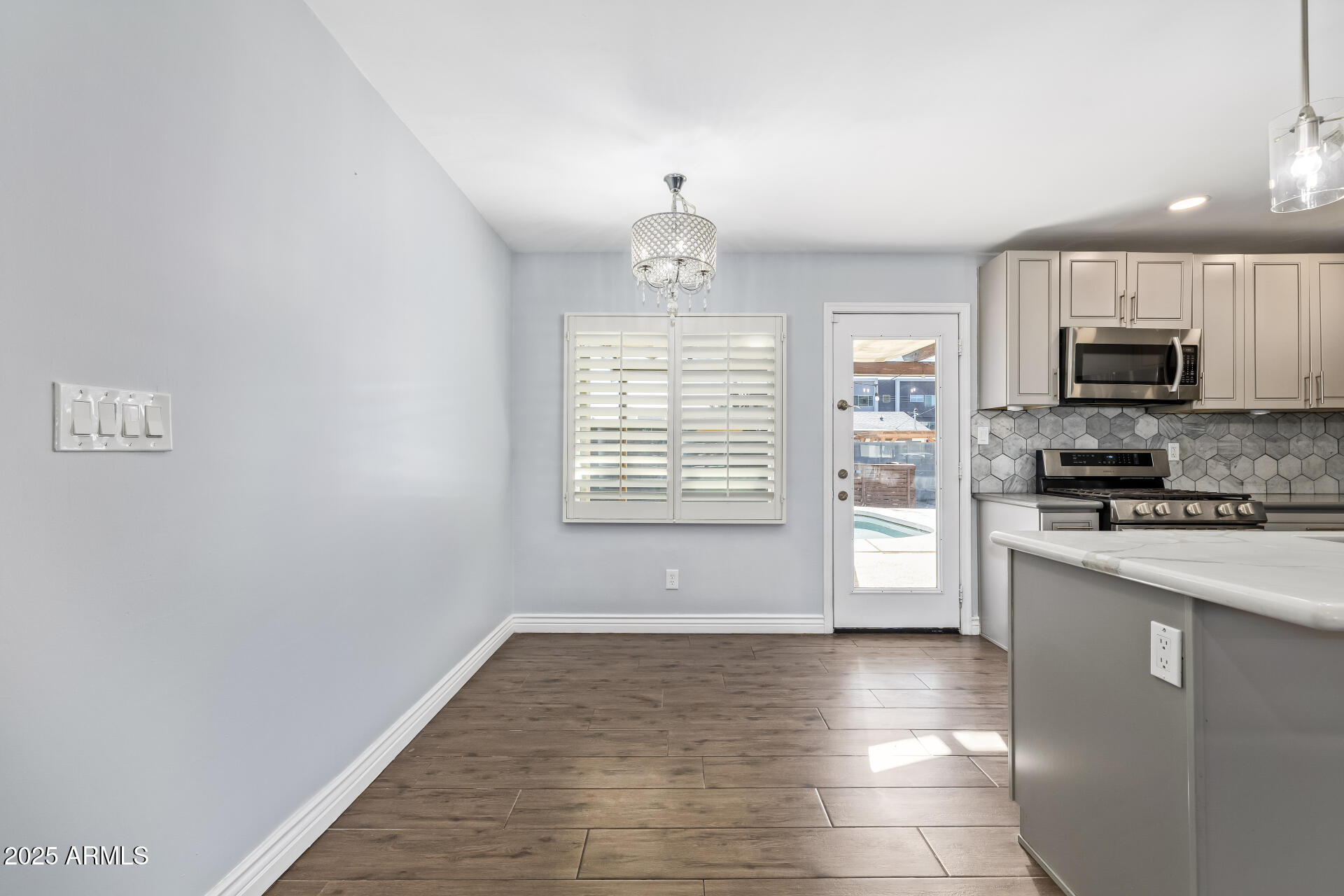 2439 East Minnezona Avenue Phoenix, AZ 85016 - Photo 9 of 25 a kitchen with stainless steel appliances a refrigerator sink and microwave