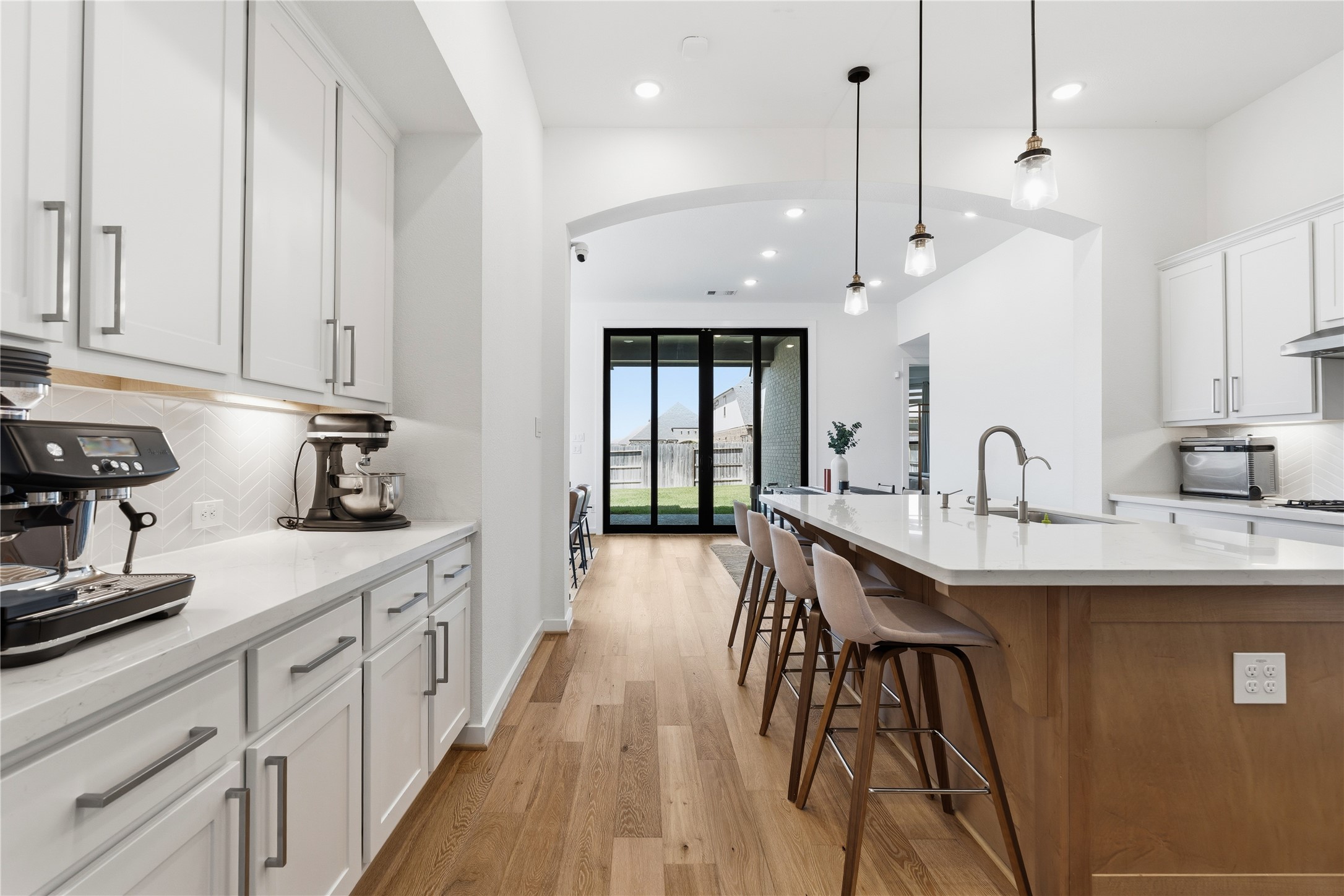 416 Bartlett Street Webster, TX 77598 - Photo 5 of 49 Chef's kitchen with coffee bar, quartz island, pendant lights, and yard views