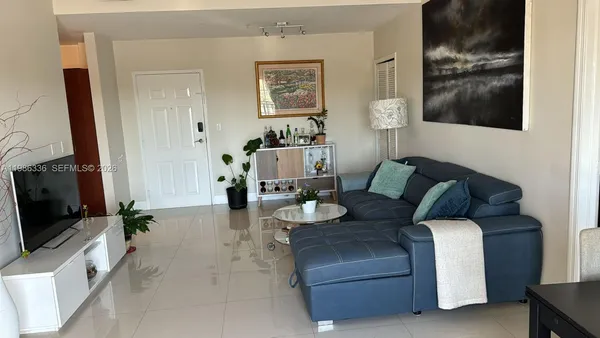 a living room with furniture and a flat screen tv