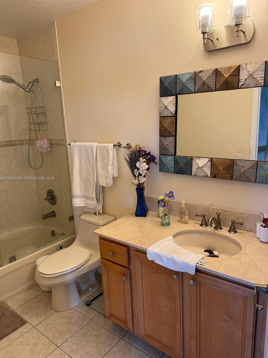 5271 Southwest 8th Street, Unit 405 Miami, FL 33134 - Photo 3 of 8 a bathroom with a sink toilet and shower