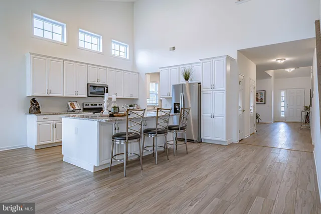 a kitchen with appliances a sink and cabinets