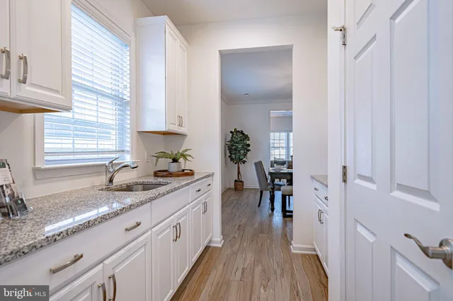 a kitchen with sink and stove top oven