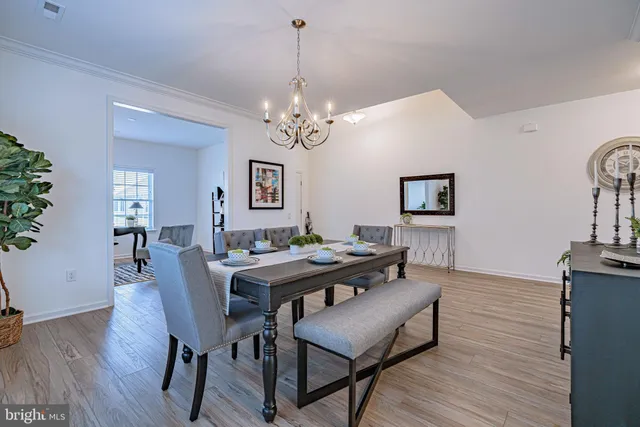 a view of a dining room with furniture wooden floor and a chandelier
