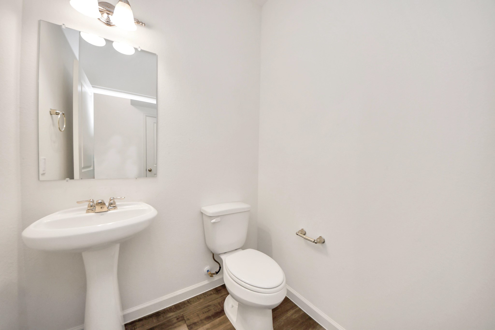 10303 Rose Mar Drive, Unit B Rosharon, TX 77583 - Photo 17 of 49 a bathroom with a toilet sink and mirror