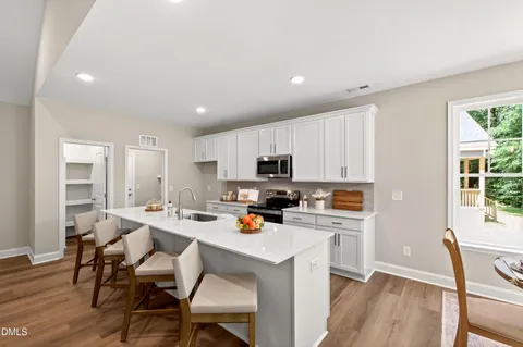 a view of kitchen with cabinets table and chairs