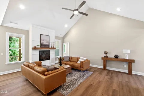 a living room with furniture and a view of kitchen