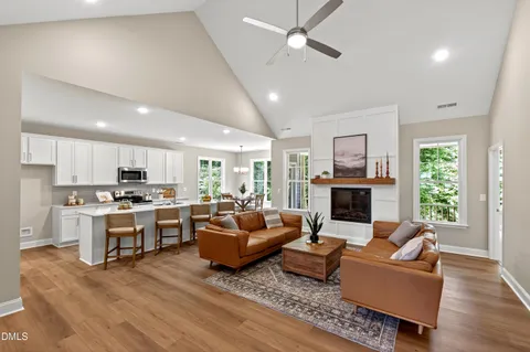 a kitchen with a dining table chairs and refrigerator