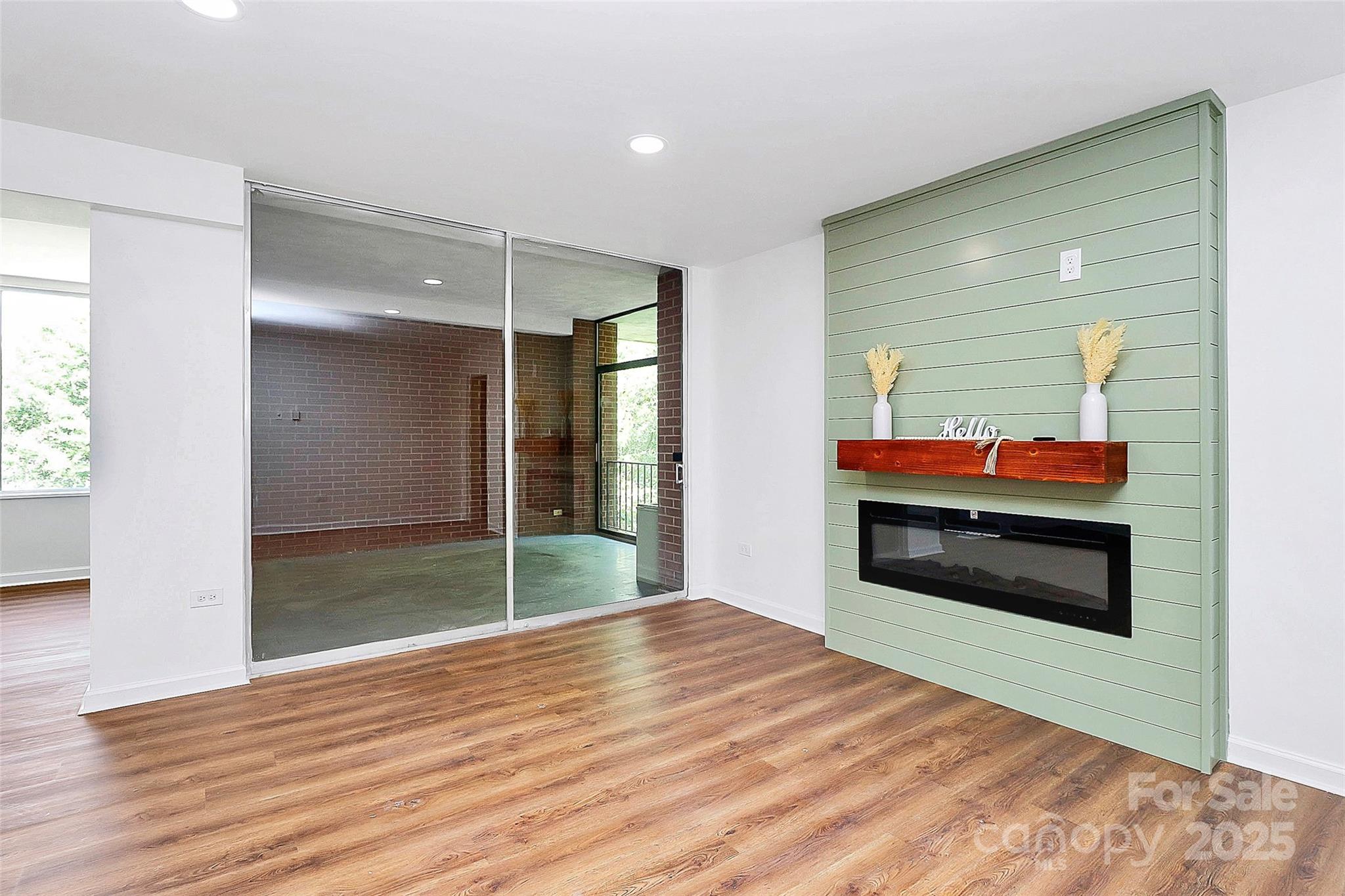 1300 Queens Road, Unit 405 Charlotte, NC 28207 - Photo 3 of 36 a room with wooden floor and window