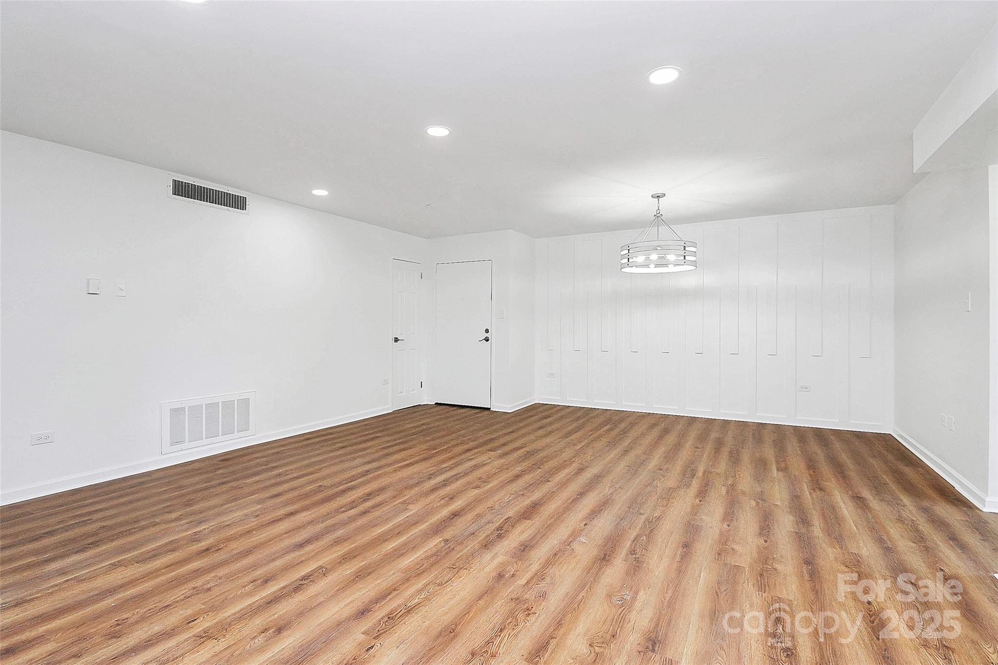 1300 Queens Road, Unit 405 Charlotte, NC 28207 - Photo 4 of 36 a view of empty room with wooden floor