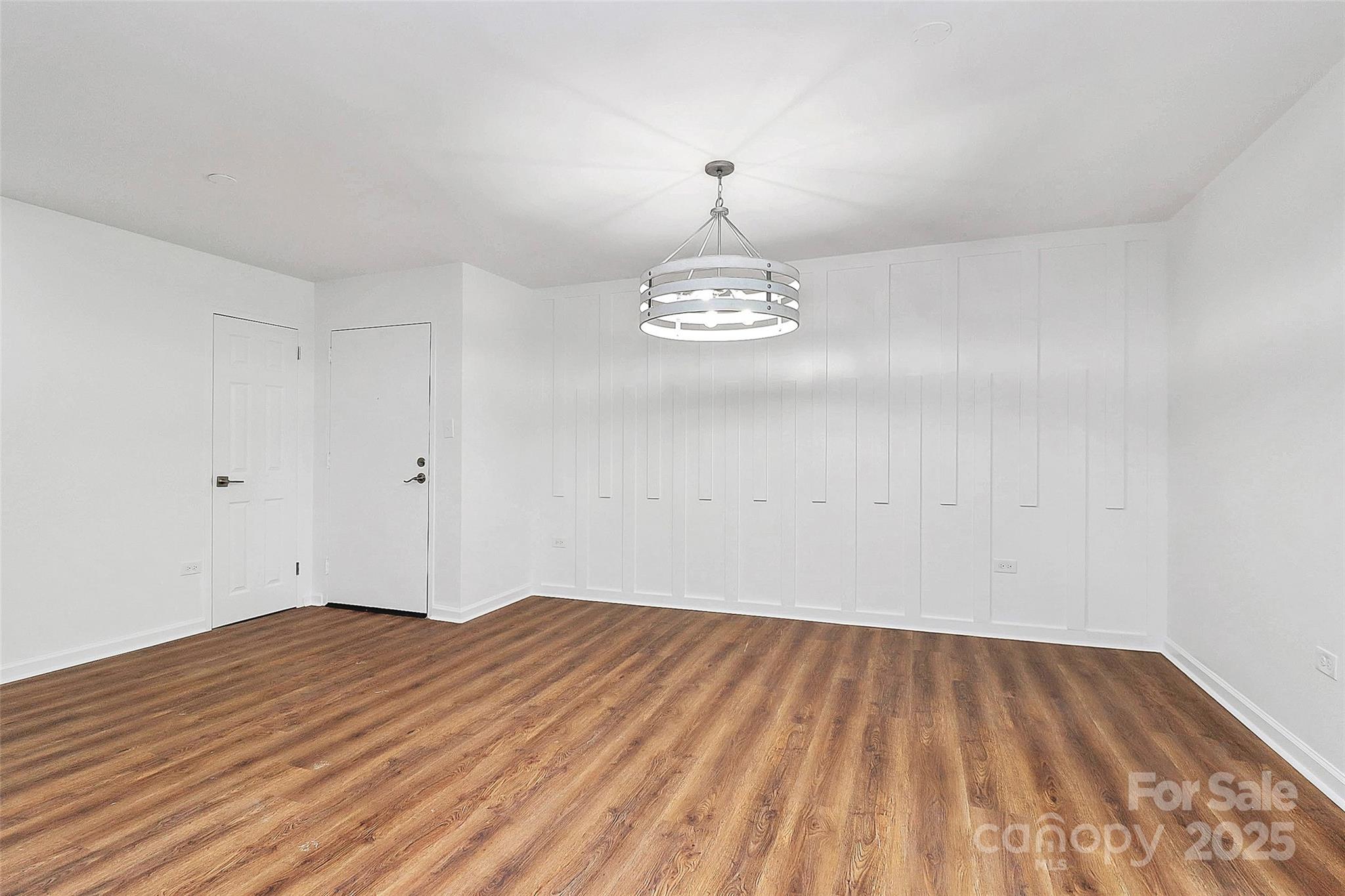 1300 Queens Road, Unit 405 Charlotte, NC 28207 - Photo 5 of 36 a view of empty room with wooden floor