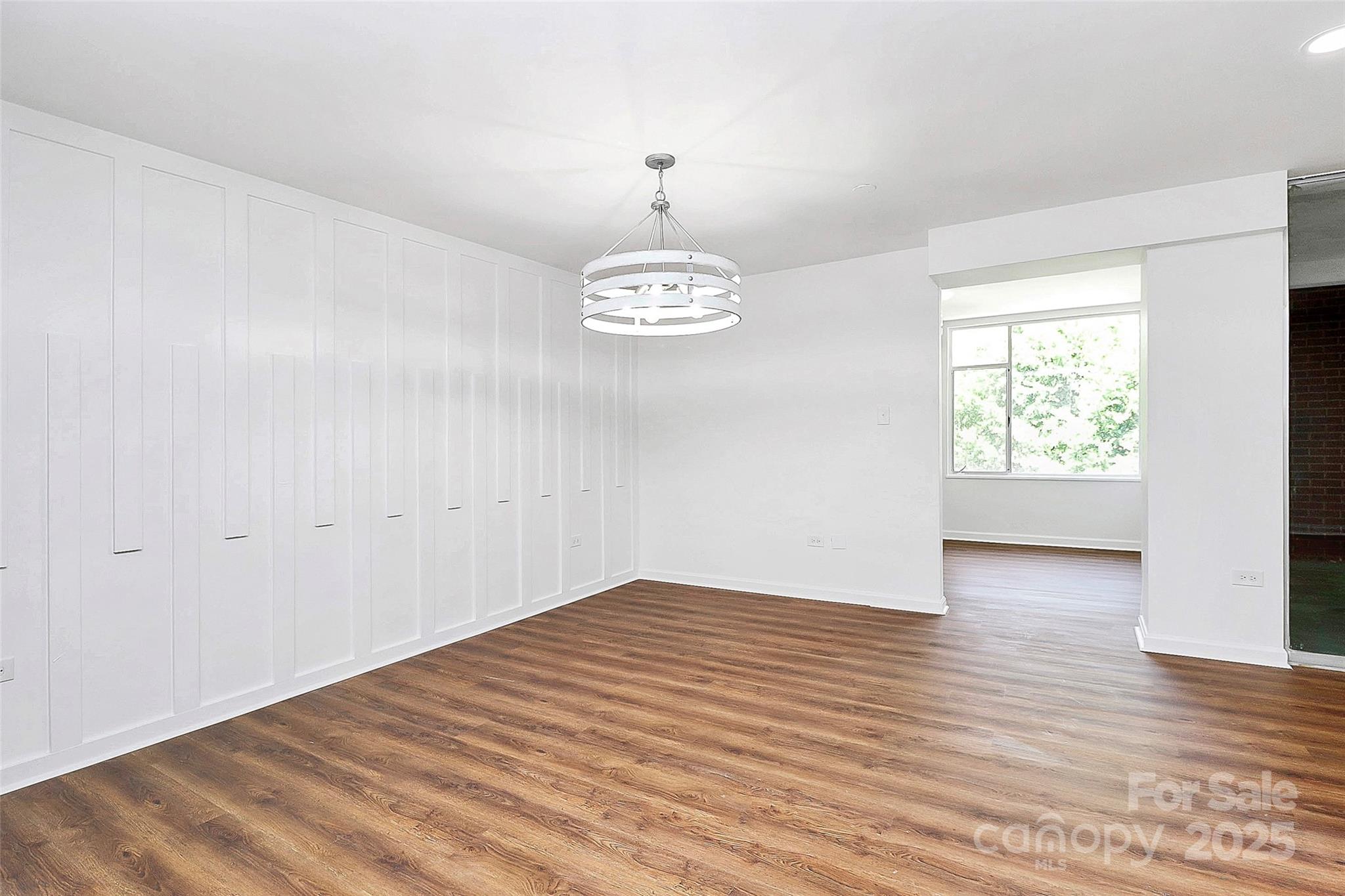 1300 Queens Road, Unit 405 Charlotte, NC 28207 - Photo 6 of 36 wooden floor in an empty room with a window