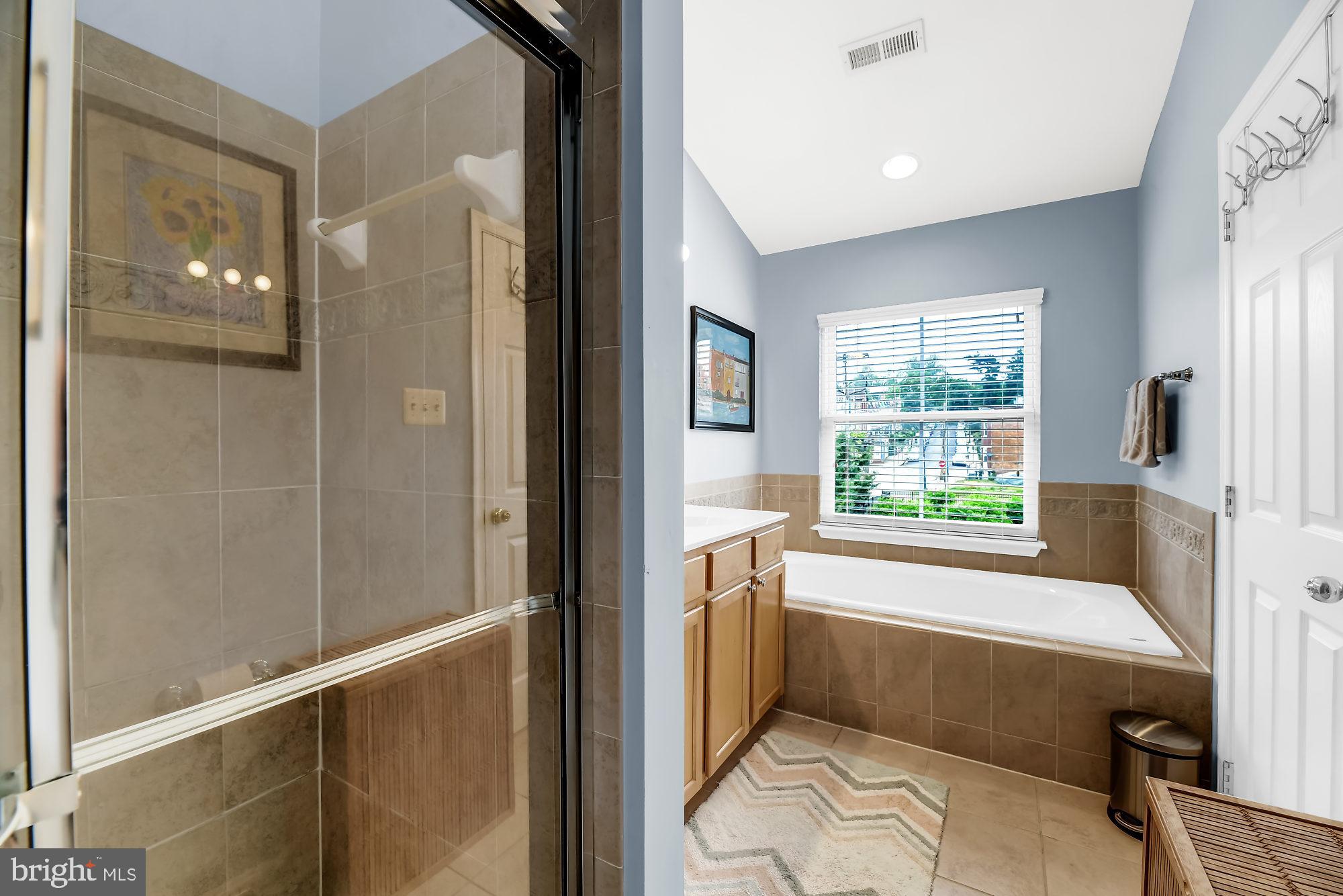 2090 Clipper Park Road Baltimore, MD 21211 - Photo 15 of 75 a bathroom with a tub shower and sink