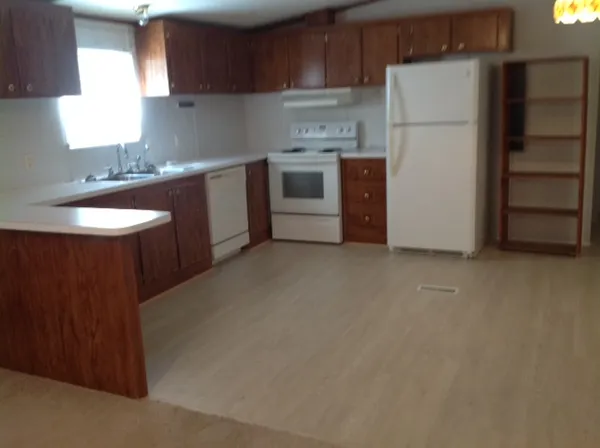 a kitchen with stainless steel appliances a refrigerator sink and cabinets